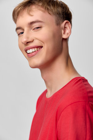 Smile, young man, red shirt, casual headshot with cheerful expression and friendly energy, bright...