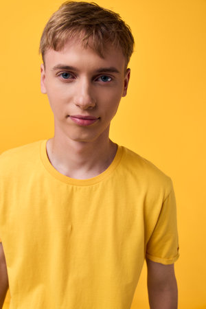 Youth, male, young man, casual fashion, studio shot with yellow background showcasing a clean,...
