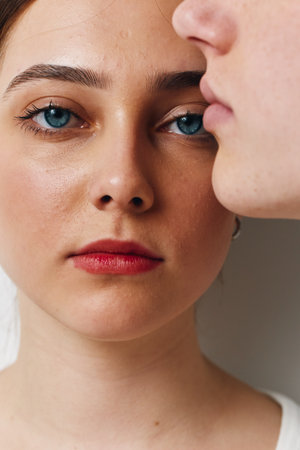 Portrait of young woman with blue eyes and red lips, close up face and natural skin texture with...
