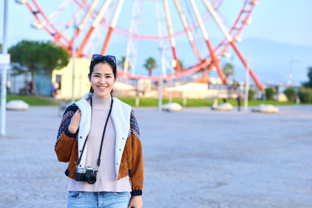 Woman with camera exploring park amusement, outdoor leisure, smile, photography vibe, traveler...