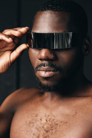 Creative conceptual portrait of African man wearing futuristic reflective visor in visual style....