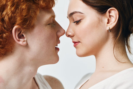 Couple, man and woman close together looking into each others eyes for romance and love. Portrait with intimate and gentle expression, connection, relationship, affection at home.の写真素材