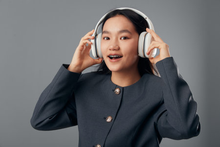 Young woman wearing headphones smiling and enjoying music with modern wireless technology. Portrait...