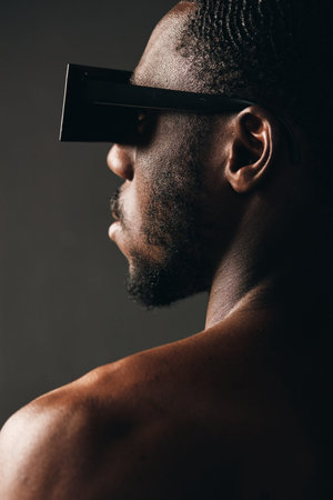 African man with dark skin wearing futuristic black glasses in creative conceptual visual style....