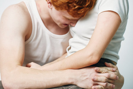 Couple in white clothes embracing with hands clasped closeup body gesture for love, comfort,...