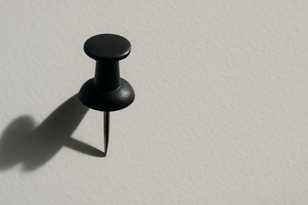 Black pushpin on a white wall with shadow, 3d illustrationの素材