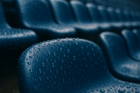 Close up of blue seats with water drops in cinema auditorium.の素材
