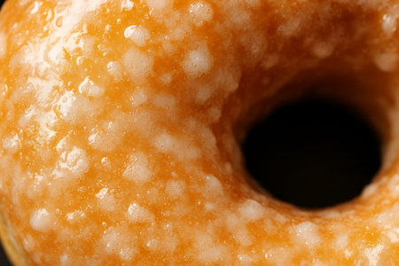 Close up of tasty donut on a black background. Macro.の素材