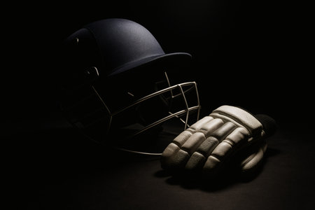 Cricket Gear Spotlight on Dark Background â Professional Sports Equipment with Dramatic Lightingの素材