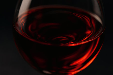 Elegant Red Wine Glass with Reflective Surface. Drink, beverage, wine, alcohol, sophisticated, gourmetの素材