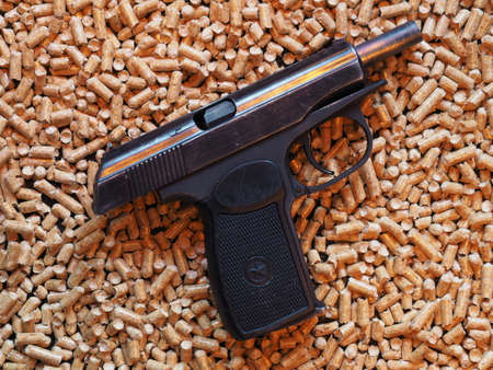 Gun on the background of pelletsの写真素材