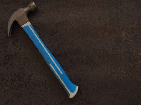 Construction hammer on a black textured backgroundの写真素材