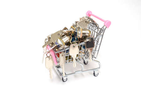 Key workshop. Lots of keys in a mini shopping cart on a white background.の写真素材