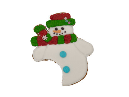 Christmas gingerbread on a white background. A bitten snowman in a scarf. Brown homemade cookies in colored icing sugar. New year ornament handmade decoration.の写真素材