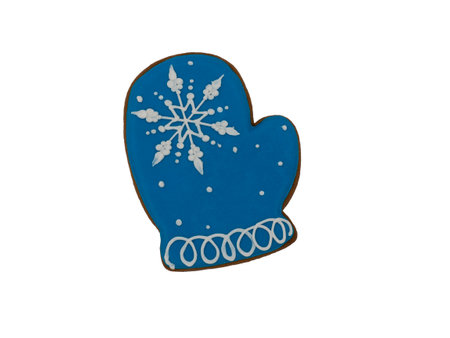 Christmas gingerbread on a white background. Blue mitten with a snowflake. Brown homemade cookies in colored icing sugar. New year ornament handmade decoration.の写真素材