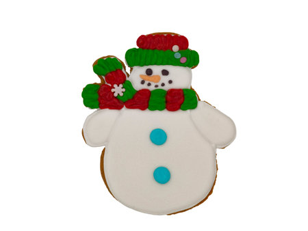 Christmas gingerbread on a white background. A snowman in a scarf. Brown homemade cookies in colored icing sugar. New year ornament handmade decoration.の写真素材