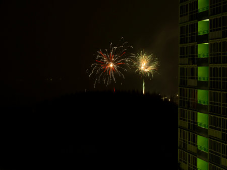 New Year or Christmas fireworks in the Russian suburbs. Composite photo of a color salute in the courtyard of a sleeping area of the city.の写真素材