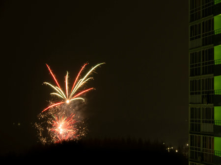 New Year or Christmas fireworks in the Russian suburbs. Composite photo of a color salute in the courtyard of a sleeping area of the city.の写真素材