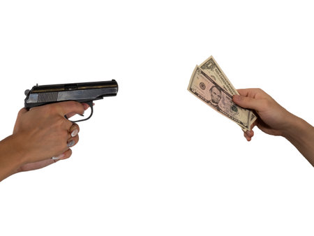 Robbery, extortion, crime. A female thug threatens with a gun in her hands. The male victim gives away dollar bills. The concept of equality, a photo isolated on a white background.の写真素材