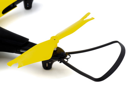 A broken black and yellow flight drone. Damage to the quadcopter propeller from impact. Photo isolated on a white background. The concept of repair in the workshop.の写真素材