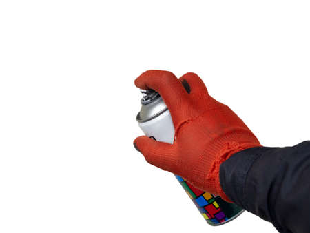 A man holds an aluminum spray can with graffiti or airbrushing paint in his hand with a glove in the...