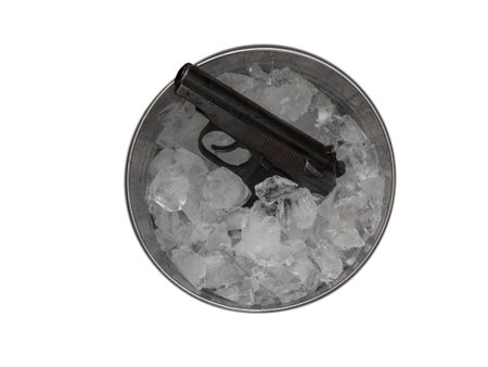 Police 9mm pistol frozen in a bucket with crushed ice cubesの写真素材