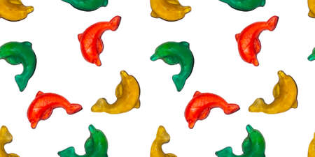 Seamless repeating pattern of marmalade food dolphins. Banner or wallpaper of edible sea animals on a white background.の写真素材