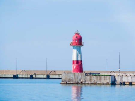 Concrete blocks breakwater and lighthouse in Sochi port on the Black Sea, Krasnodar Krai. Marine, industrial coastal landscape.の写真素材