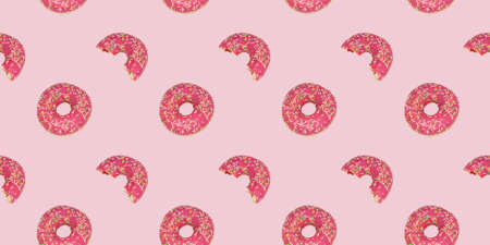 A seamless repeating pattern of a glamorous pink donut. Bright rose background with a bitten and whole donut.の写真素材