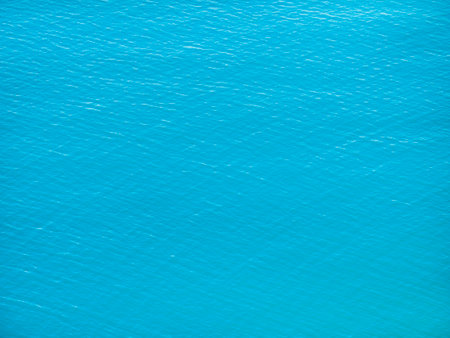The surface texture of calm turquoise sea water. Blue smooth ocean view from above, aerial photography. Background of green lake water.の写真素材