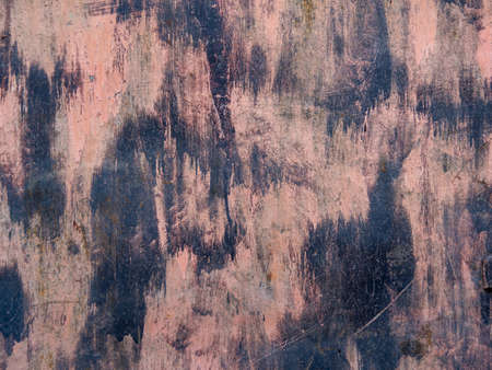 The texture of a dirty, scratched iron wall. Pink grunge background with black paint spots on top of...