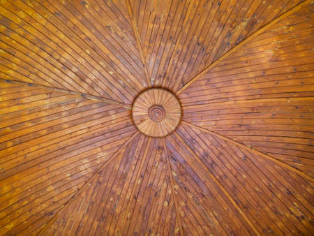 The texture of a spacious wooden dome made of painted boards is viewed from the bottom up.の写真素材