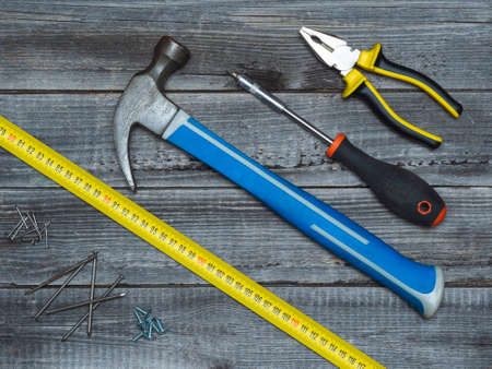 A home working tool on a wooden background of a table made of boards.
