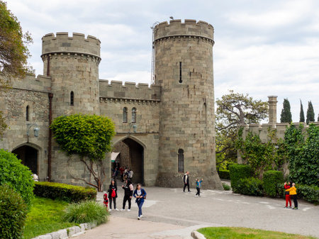 Alupka, Crimea - May 12.2021: Vorontsov Palace, fortress in detail. People in the park, the castle on a guided tour.のeditorial素材