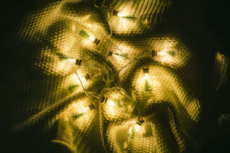 A beautiful handmade craft Christmas tree garland made of glass bottles with a Christmas tree and...