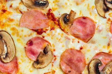 Pizza texture ham with mushrooms close-up. Italian cuisine, fast food.の写真素材
