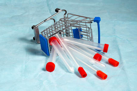Express PCR tests, a smear for virus. Sterile medical probes tampons tupfer lie in a shopping cart....