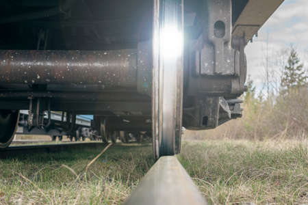 Train wheel on a railway with a bottom view. The glare on the steel wheel of the transport.の写真素材