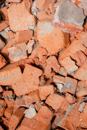 Texture of big pieces of broken red brick in full frame. construction background.