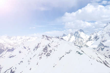 Natural landscape of white blue snowy mountain range of the Caucasus mountains of Elbrus against a...