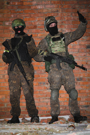 Two military man in tactical helmet and camouflage posing and selfie.