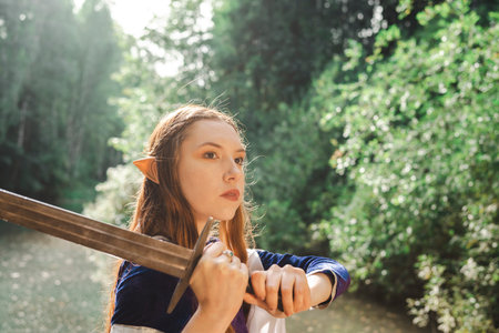 Red hair woman elf warrior in a blue dress with sword weapon in the forest lake.