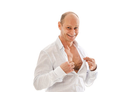 Portrait charismatic of a 50 year old man with a receding hairline in an unbuttoned white striped shirt. Photo in the studio on a white background.の写真素材
