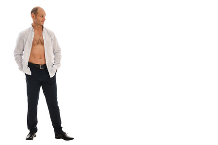Portrait charismatic of a 50 year old man with a receding hairline in an unbuttoned white striped shirt. Photo in the studio on a white background.の写真素材