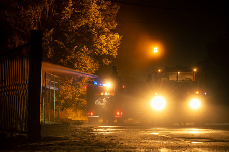 Extinguishing a fire in a building with a water cannon on a fire truck.