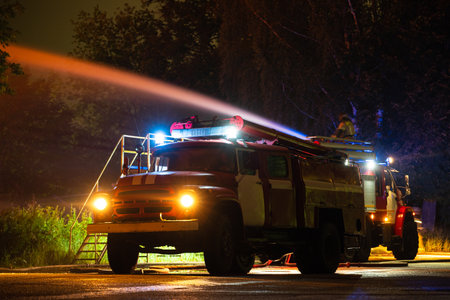Extinguishing a fire in a building with a water cannon on a fire truck.