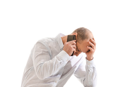 Stressed 50 year old man call or smartphone, photo isolated on white background.の写真素材