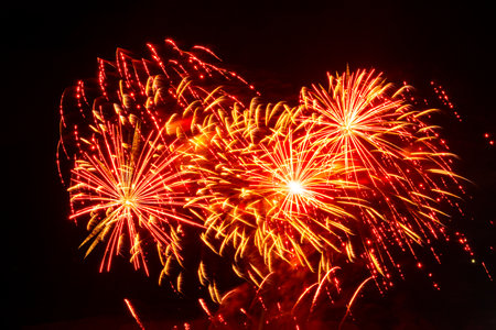 Colorful fireworks exploding in the night sky during a festive celebration or holiday event.の写真素材
