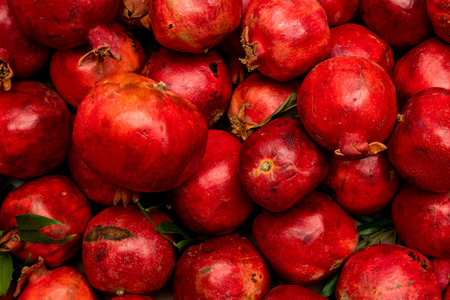 Fresh ripe pomegranates, vibrant red fruit, healthy, natural, antioxidant-rich, organic produce, close-up shot.の写真素材