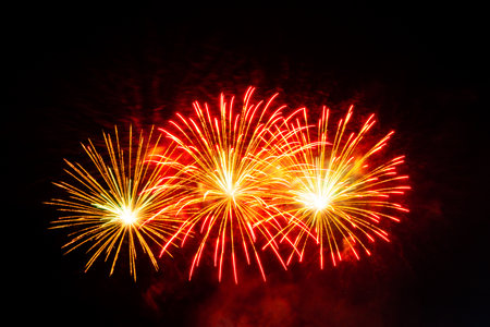 Colorful fireworks exploding in the night sky during a festive celebration or holiday event.の写真素材